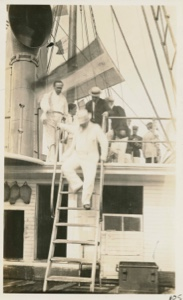 Image of President Roosevelt descending ladder of the S.S.Roosevelt.  Peary at far left
